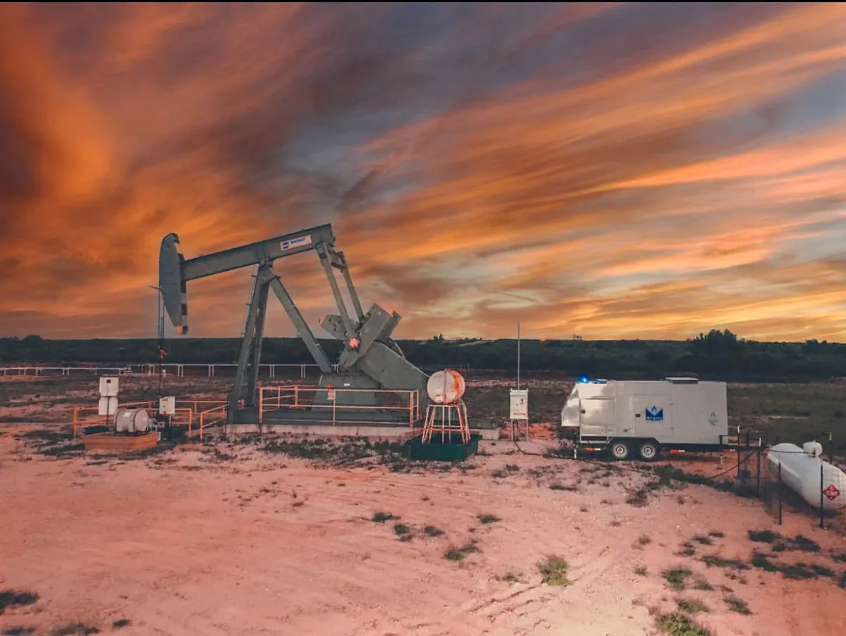 MESA natural gas generator next to a pumpjack in an oil field